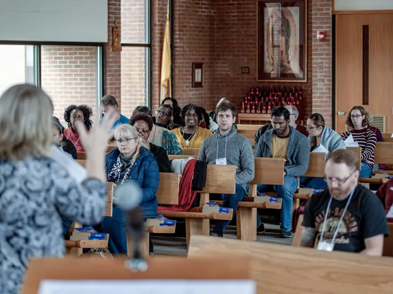 People sitting in church pews